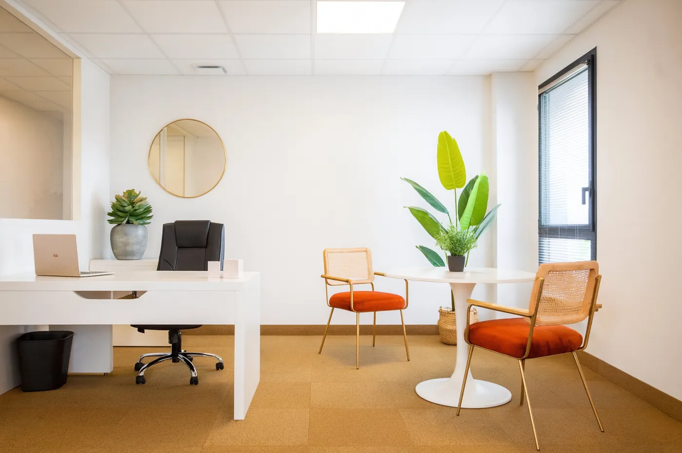 Executive office at the Garosud coworking centre, white desk and orange velvet chairs